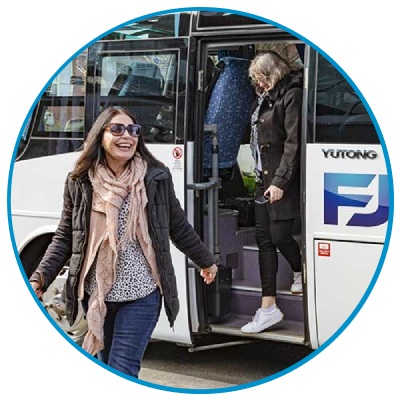 a group of people standing in front of a bus