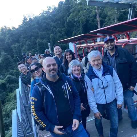 a group of people standing in front of a bridge