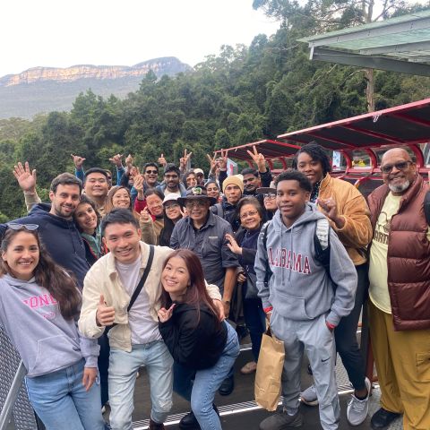 Karen Goh, Jeremy Gumbs, Star Parker standing in front of a crowd posing for the camera