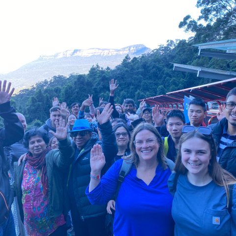 a group of people standing in front of a crowd posing for the camera