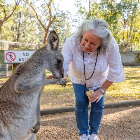a little girl holding a dog