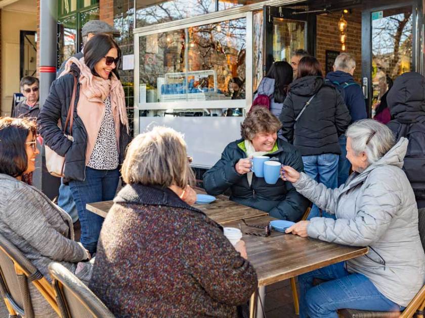 a group of people sitting in a chair talking on a cell phone