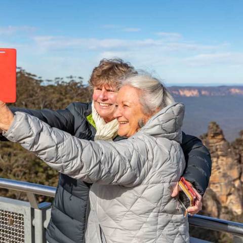 a man standing next to a fence