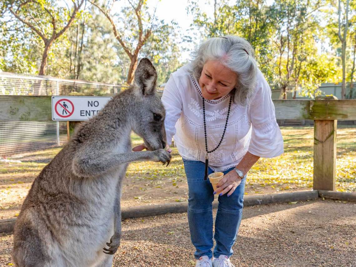 a little girl holding a dog