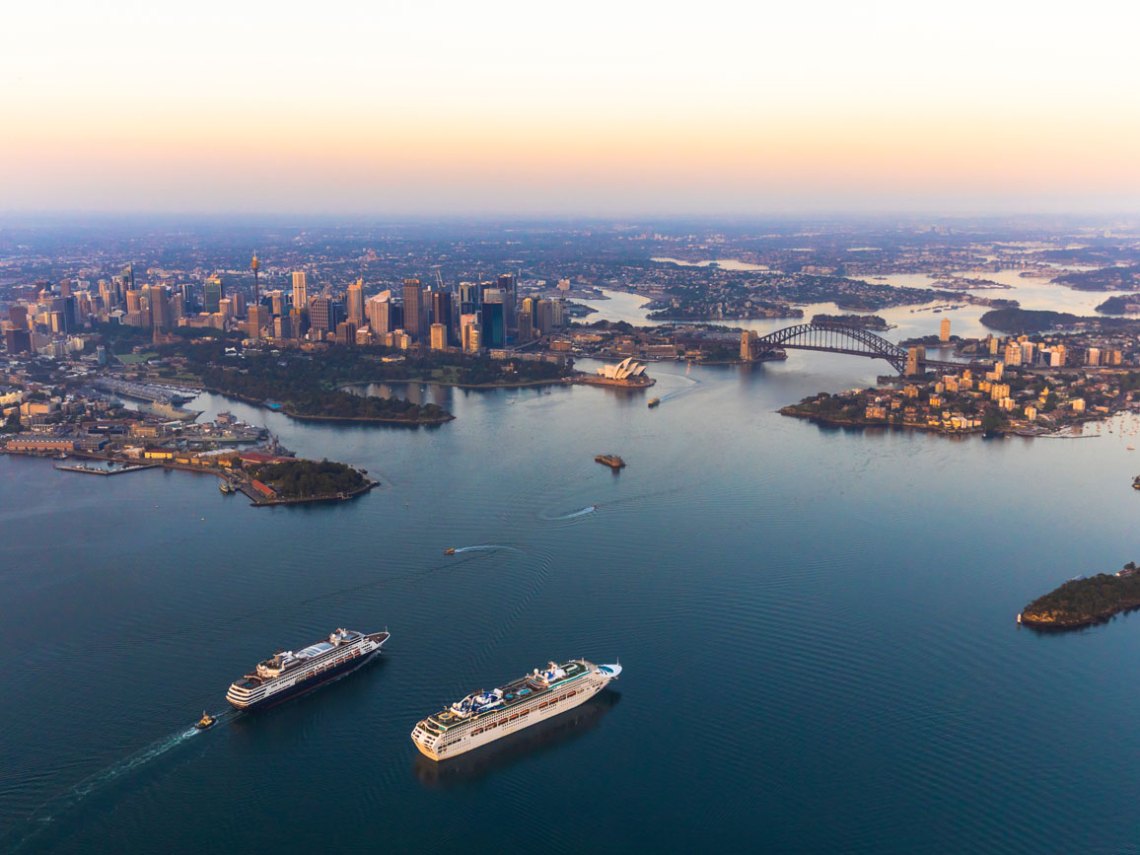 a large body of water with a city in the background